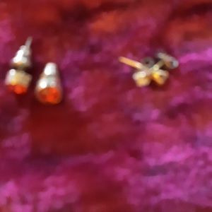 Two pair of tiny earrings one clear one red tiny!